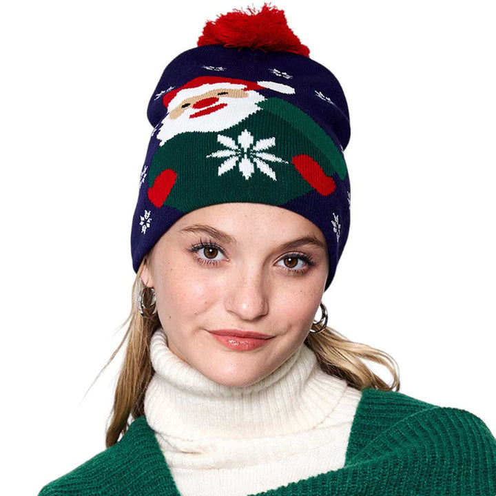 Navy Snowy Santa Claus Pom Pom Beanie Hat. Stay stylish in the Christmas while keeping warm in this Beanie. With an adorable design featuring a colorfully decorated festive scene, this hat is sure to keep heads cozy and toasty in cool weather. Gift it to anyone in your life for a functional and fashionable accessory.