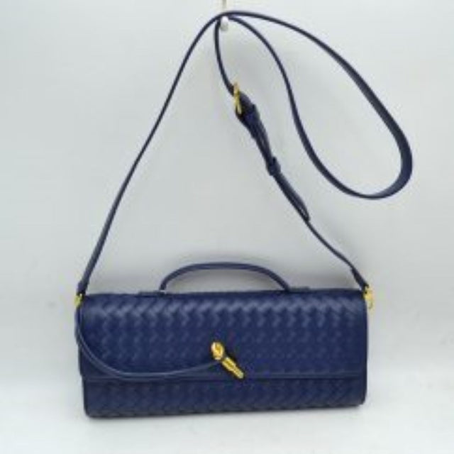 Navy blue This structured shoulder bag features an intricate woven exterior design with an elongated East-West silhouette, making it a sophisticated choice for modern everyday use. The front flap is detailed with a slim, flat top handle that rests close to the body and is highlighted by a distinctive, polished gold-tone metal clasp accent. Completed with a matching adjustable long shoulder strap secured by gold-tone hardware, this versatile bag can be easily styled as a shoulder bag or a crossbody.