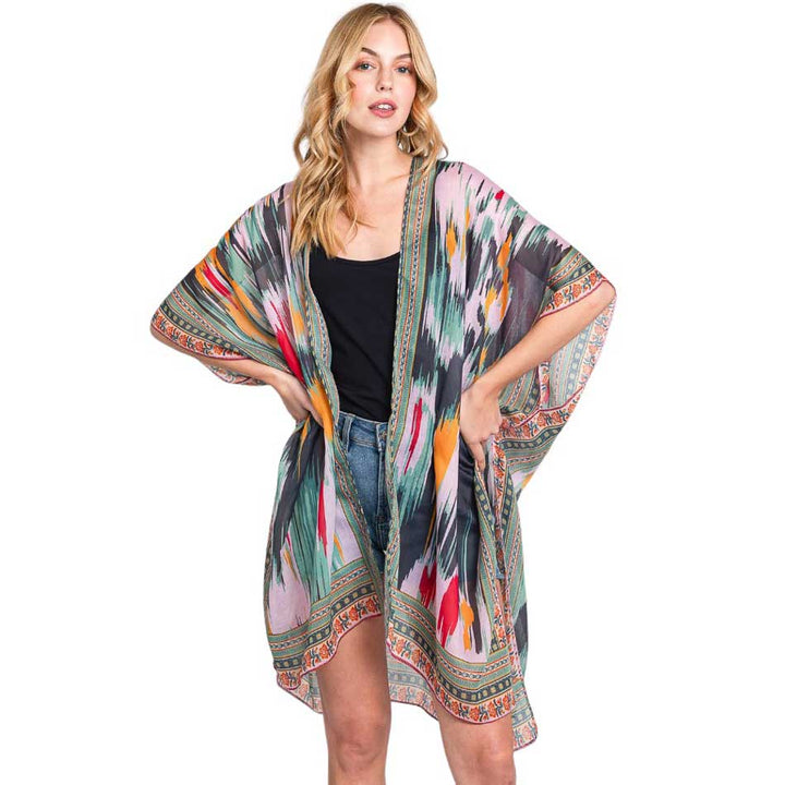 Olive Green Geometric Trim Tie Dye Print Kimono Poncho, Expertly crafted with a stylish geometric trim and tie dye print, our Kimono Poncho adds a touch of sophistication to any outfit. Versatile and trendy, this poncho is perfect for layering and can be dressed up or down for any occasion. Elevate your wardrobe with this piece.