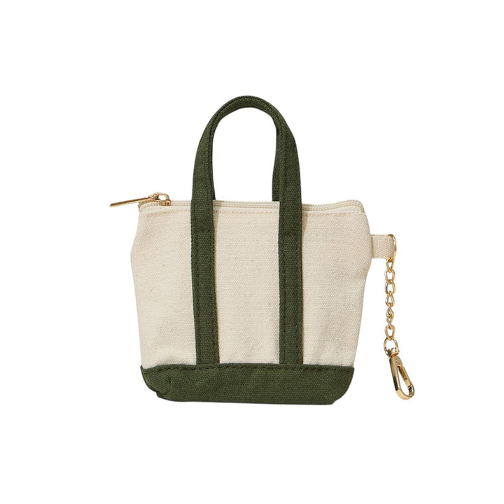 Olive Mini Canvas Pouch Bag doubles as a chic bag charm, combining style with practicality. Crafted from durable canvas, it offers a compact space perfect for carrying essentials like keys, cards, or small cosmetics. Its lightweight design attaches easily to your handbag, adding a trendy accent while keeping your valuables within reach. Ideal for those who value convenience and a polished look in everyday accessories.