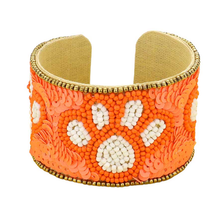 Orange White This stylish Game Day Sequin Seed Beaded Paw Accented Cuff Bracelet is the perfect way to show your team spirit. Crafted with sparkling sequins and beads, this bracelet features an eye-catching paw accent, perfect for any sports fan. Show your true allegiance on game day with this fashionable and unique accessory.