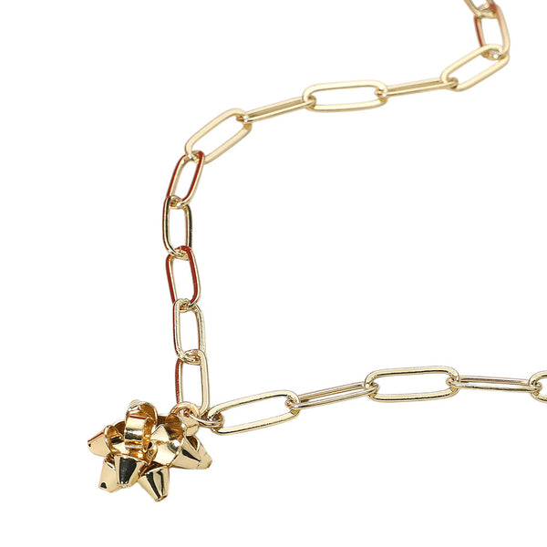Trendy chain link necklace featuring a playful gift bow charm. A bold yet charming accessory that adds a modern edge and festive flair to casual or dressed-up outfits.