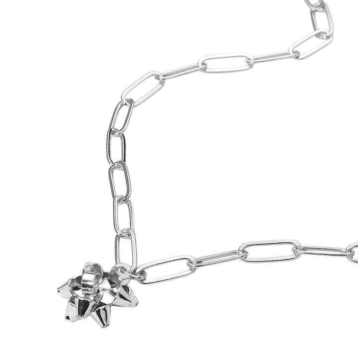 Trendy chain link necklace featuring a playful gift bow charm. A bold yet charming accessory that adds a modern edge and festive flair to casual or dressed-up outfits.