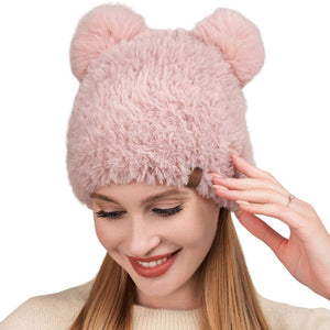 Pink Faux Fur Pom Pom Ear Beanie Hat, stay warm in style with this comfy beanie hat. Crafted with high-quality faux fur, this piece offers maximum insulation and a fashionable look. This is the perfect hat for any stylish outfit or winter dress. Perfect gift for Birthdays, Christmas, holidays etc. to your friends, family.