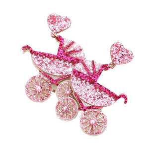 Pink Glittered Heart Stroller Dangle Earrings, make a great accessory for any outfit. The lightweight earrings feature a delicate glittered heart stroller with gold-tone accents, perfect for adding sparkle and fun to any look. Lightweight and easy to wear, these earrings are sure to become your go-to accessory.