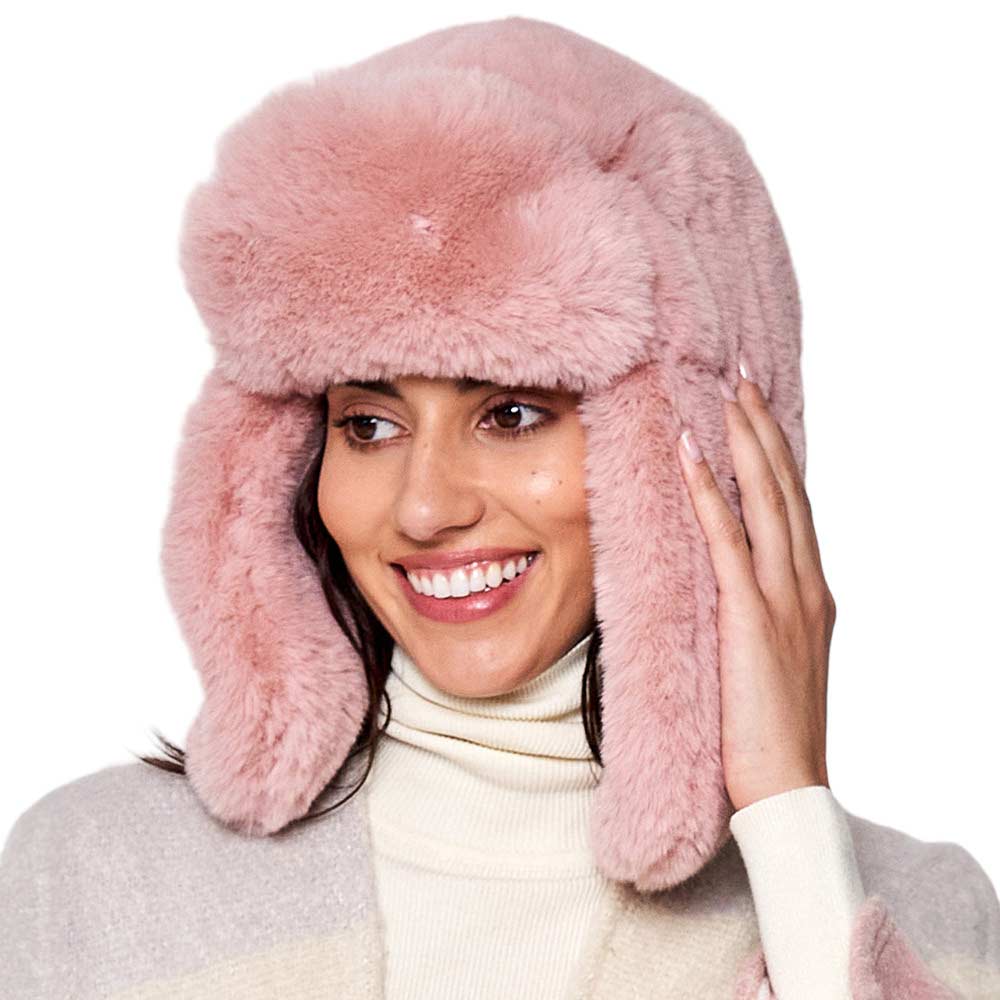Pink Solid Faux Fur Trapper Hat, is perfect for winter outdoor adventures. Crafted from soft faux fur, the hat will comfortably protect your head from the cold while looking stylish. With its windproof design, this hat is a must-have for winter weather. Ideal gift for your friends and family members on colder days.