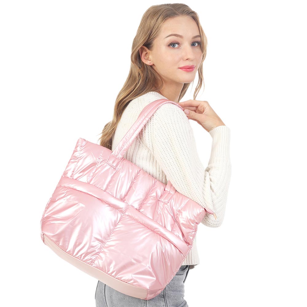 Pink Solid Puffer Tote Shoulder Bag, is an impressive combination of fashion and practicality. Made of durable material, this shoulder bag offers superior protection from impacts with its padded construction, and also features a shoulder strap for added convenience. Give one of these bags as a gift to your favorite ones.