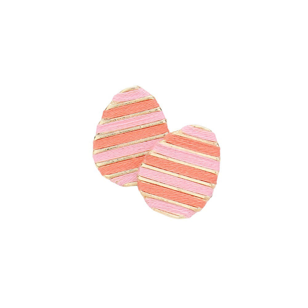 Pink Thread Wrapped Easter Egg Stud Earrings are expertly crafted and offer a unique twist on traditional Easter accessories. The thread wrapping adds texture and depth, making them a beautiful addition to any outfit. Handmade with quality materials, these earrings are sure to become a staple in your jewelry collection.