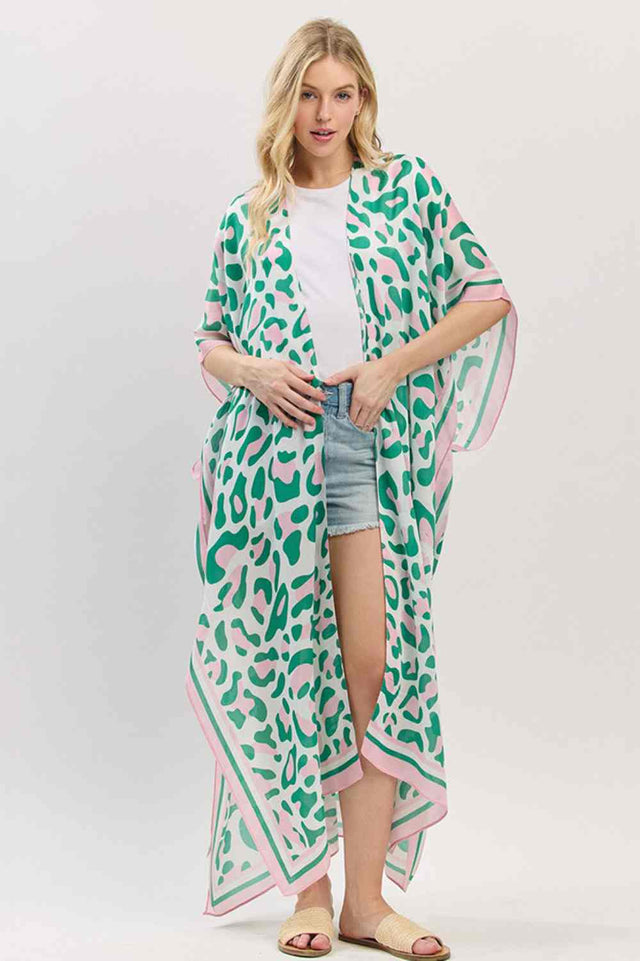 Pink Green Effortless summer style meets timeless leopard print in this lightweight open-front kimono. Crafted from breathable 100% polyester, it drapes beautifully over swimwear or casual outfits for an instant beach-ready look. The generous 35" x 47.5" dimensions provide comfortable coverage without bulk, making it perfect for layering on warm days. Whether you're heading to the shore or poolside, this versatile piece transitions seamlessly from day to evening wear.