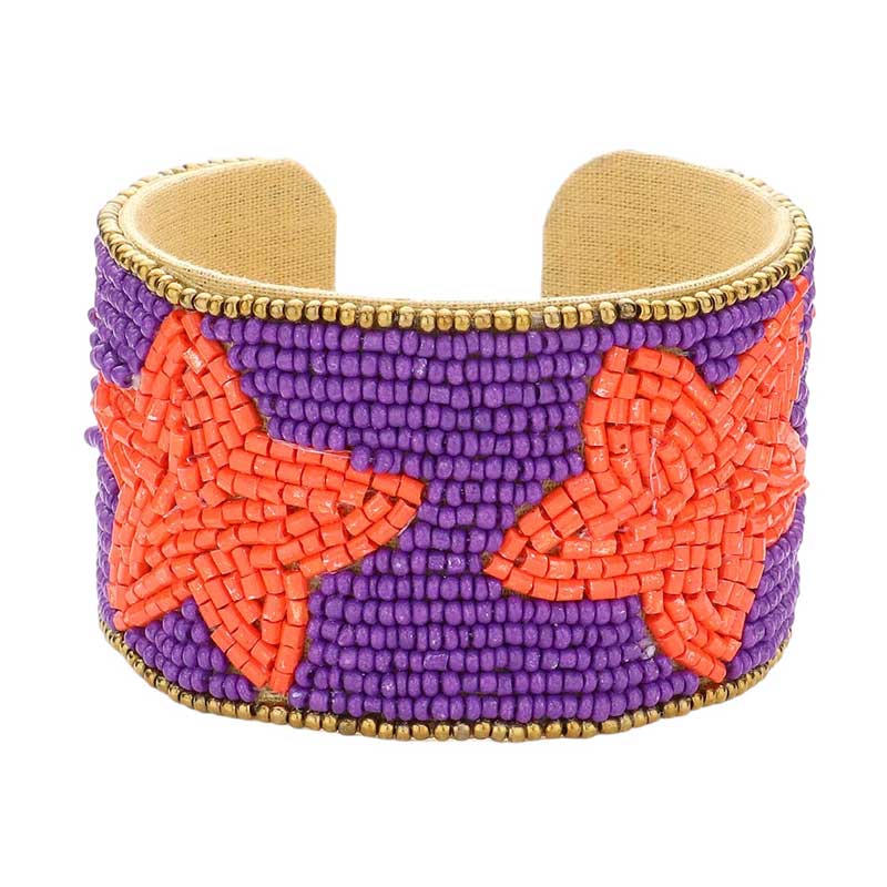 Purple Orange This Game Day Beaded Star Accented Cuff Bracelet adds a stylish touch to any ensemble. The beaded star accents on the cuff give it a unique, eye-catching design, perfect for game day or any day. Wear it to show your support for your favorite team - you're sure to stand out from the crowd. 