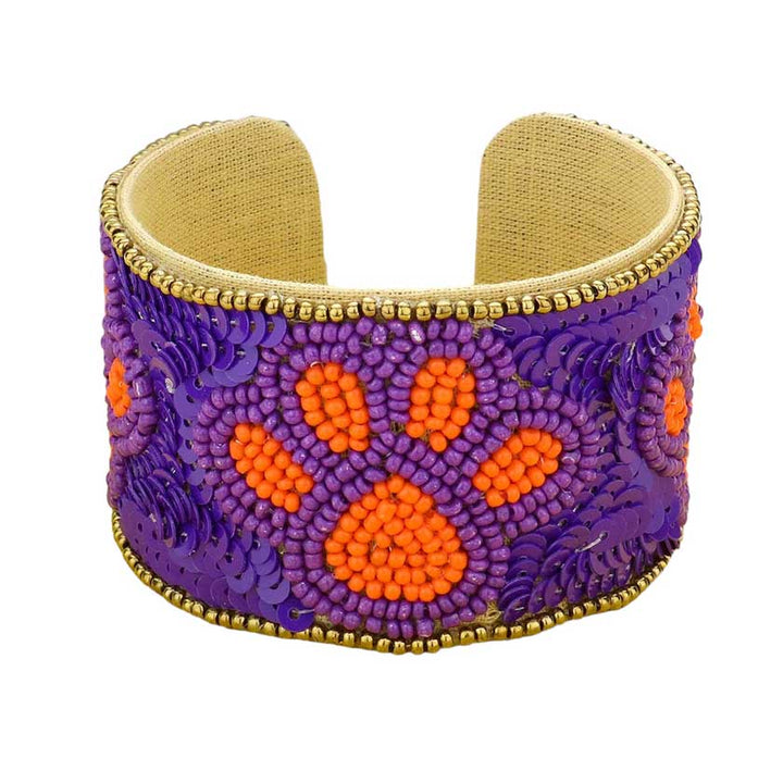 Purple Orange This stylish Game Day Sequin Seed Beaded Paw Accented Cuff Bracelet is the perfect way to show your team spirit. Crafted with sparkling sequins and beads, this bracelet features an eye-catching paw accent, perfect for any sports fan. Show your true allegiance on game day with this fashionable and unique accessory.