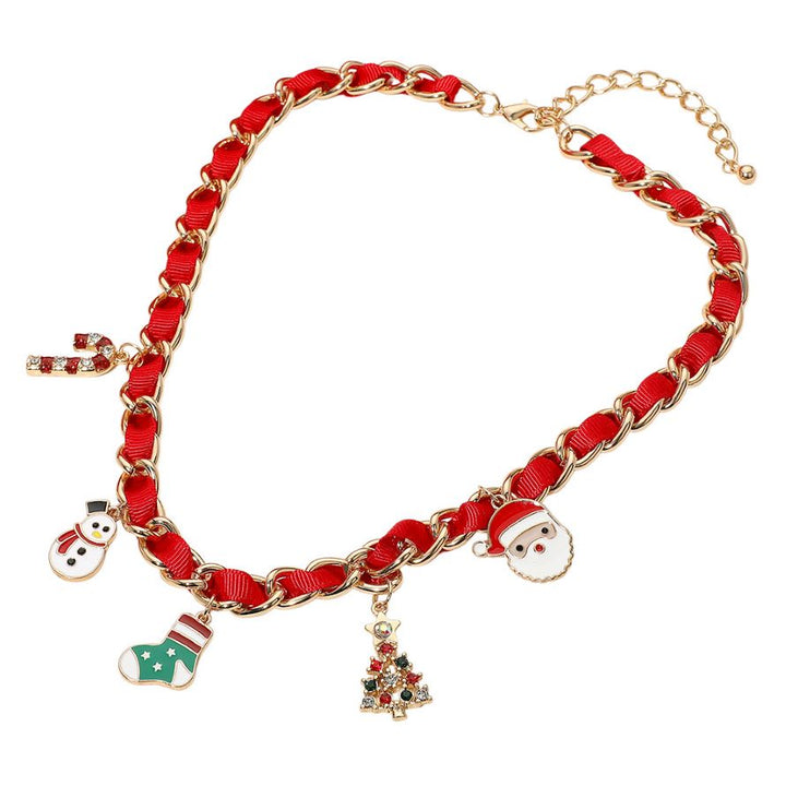 Holiday-themed necklace with enamel charms including a snowman, stocking, candy cane, Christmas tree, and Santa. Gold-tone chain interwoven with ribbon adds festive style. Made of iron, ribbon, and enamel.