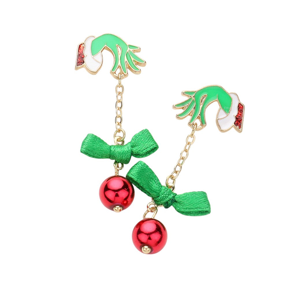 Red-Enamel Grinch Hand Bow Bell Dropdown Earrings are the perfect addition to your holiday wardrobe. The enamel detailing adds a touch of whimsy, while the hand bow and bell design make for a unique statement piece. Crafted with high-quality materials, these earrings are both stylish and durable. 