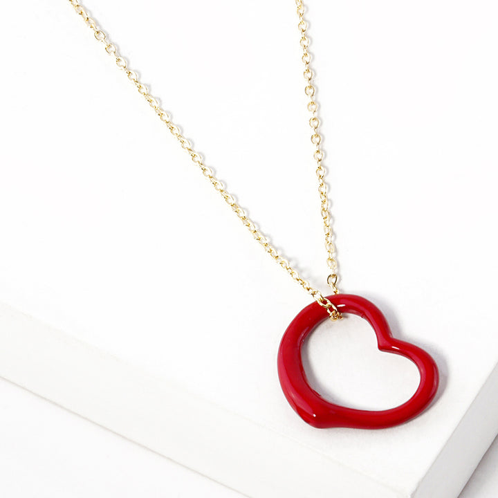 Red Metal Heart Cut-Out Pendant Necklace showcases a modern cut-out design, adding a touch of elegance to any outfit. Made with high-quality materials, this necklace is both durable and stylish. Elevate your look with this versatile accessory that perfectly blends beauty and functionality. 