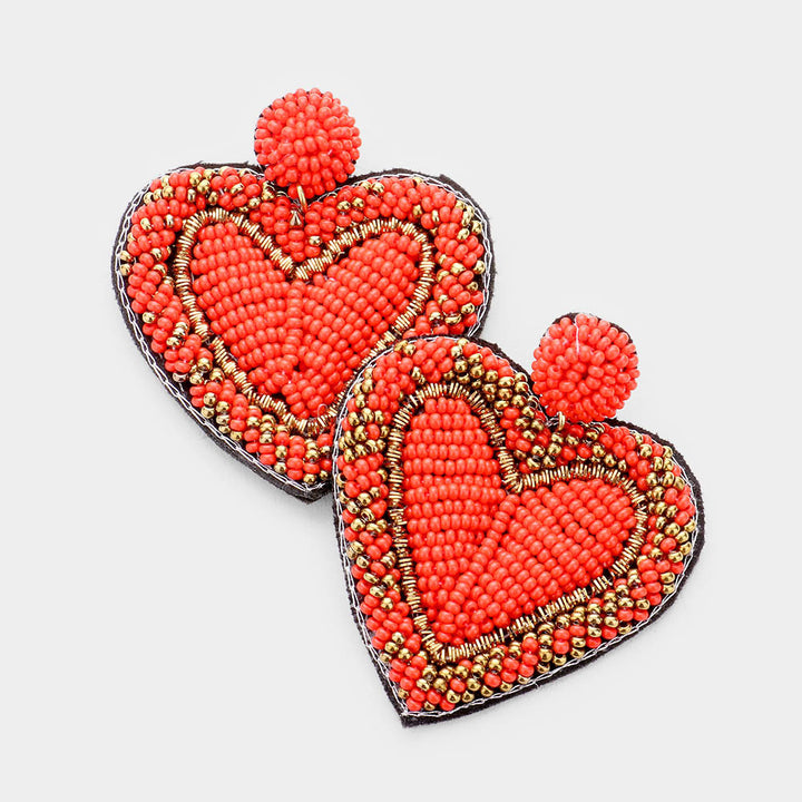 Red Seed Bead Heart Earrings are handcrafted with tiny seed beads, making them lightweight and comfortable to wear. Perfect for adding a touch of whimsy to any outfit, these earrings are ideal for everyday wear or special occasions. The unique heart shape adds a romantic and playful touch to your look.