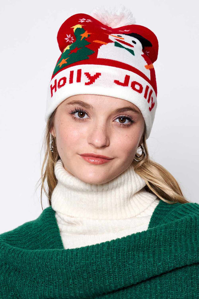 Red Holly Jolly Christmas Holiday Pom Beanie features festive holiday lettering topped with a fluffy pom for a cheerful seasonal look. Designed with a soft stretch fit, it delivers cozy warmth while adding merry Christmas charm to your cold-weather outfits.