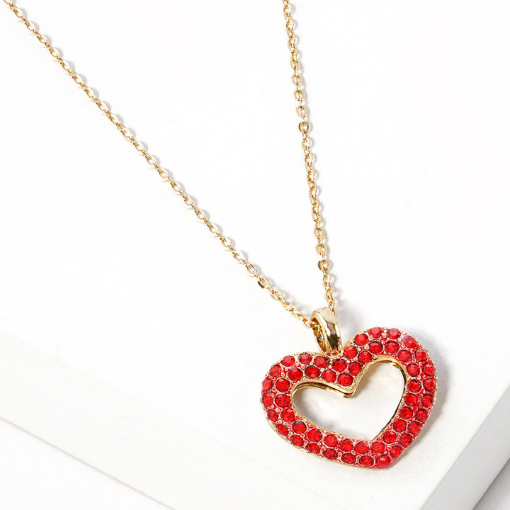 Rhinestone Embellished Open Heart Pendant Necklace is the perfect accessory for adding a touch of glamour to any outfit. Featuring sparkling rhinestones and a dainty open-heart pendant, this necklace exudes elegance and sophistication. With its versatile design, it can be worn for any occasion and is sure to make a statement. Elevate your style with this stunning piece.