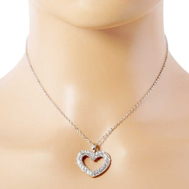 Rhinestone Embellished Open Heart Pendant Necklace is the perfect accessory for adding a touch of glamour to any outfit. Featuring sparkling rhinestones and a dainty open-heart pendant, this necklace exudes elegance and sophistication. With its versatile design, it can be worn for any occasion and is sure to make a statement. Elevate your style with this stunning piece.