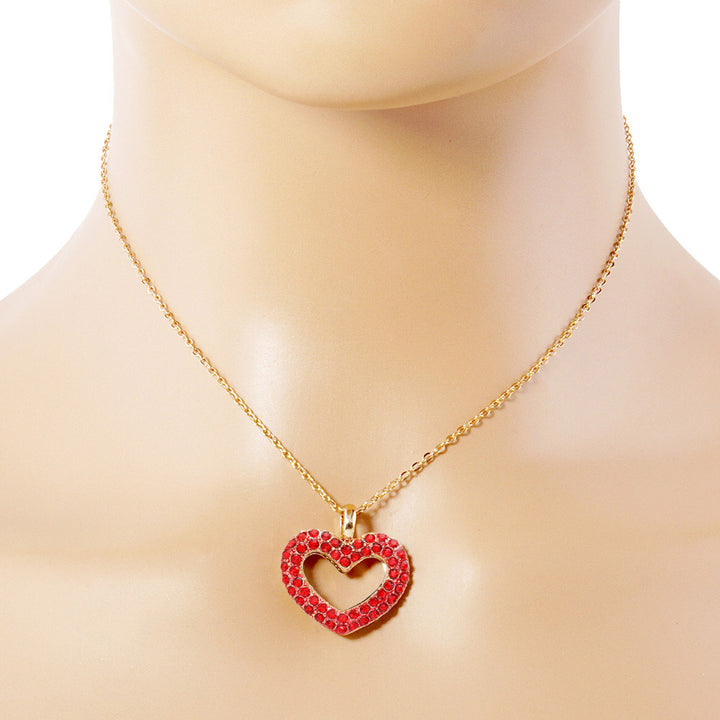 Rhinestone Embellished Open Heart Pendant Necklace is the perfect accessory for adding a touch of glamour to any outfit. Featuring sparkling rhinestones and a dainty open-heart pendant, this necklace exudes elegance and sophistication. With its versatile design, it can be worn for any occasion and is sure to make a statement. Elevate your style with this stunning piece.