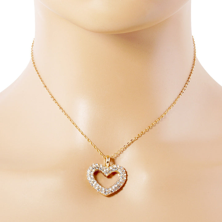 Rhinestone Embellished Open Heart Pendant Necklace is the perfect accessory for adding a touch of glamour to any outfit. Featuring sparkling rhinestones and a dainty open-heart pendant, this necklace exudes elegance and sophistication. With its versatile design, it can be worn for any occasion and is sure to make a statement. Elevate your style with this stunning piece.