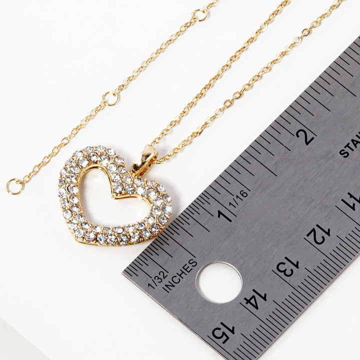 Rhinestone Embellished Open Heart Pendant Necklace is the perfect accessory for adding a touch of glamour to any outfit. Featuring sparkling rhinestones and a dainty open-heart pendant, this necklace exudes elegance and sophistication. With its versatile design, it can be worn for any occasion and is sure to make a statement. Elevate your style with this stunning piece.