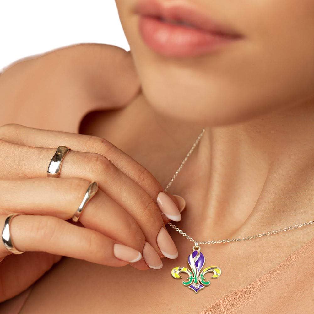 Gold Mardi Gras Enamel Fleur de Lis Pendant Necklace, Celebrate Mardi Gras with this stunning necklace. Crafted with intricately detailed enamel, this pendant is a must-have addition to any festive outfit. With its unique design and high-quality materials, this necklace is a symbol of elegance and tradition. 