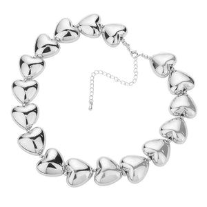 Rhodium Metal Heart Pebble Choker Necklace is a stunning piece that adds a touch of elegance to any outfit. Crafted with durable metal materials, this necklace features a beautiful heart-shaped pebble that symbolizes love and resilience. Its adjustable design ensures a comfortable fit for all. Elevate your style.