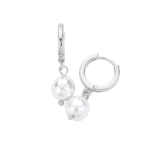 Rhodium Pearl Dangle Huggie Earrings. These elegant earrings feature a delicate pearl dangle, adding a touch of sophistication to any outfit. Crafted with high-quality materials, these earrings are both lightweight and comfortable. Perfect for any occasion, these earrings will make a stylish statement.