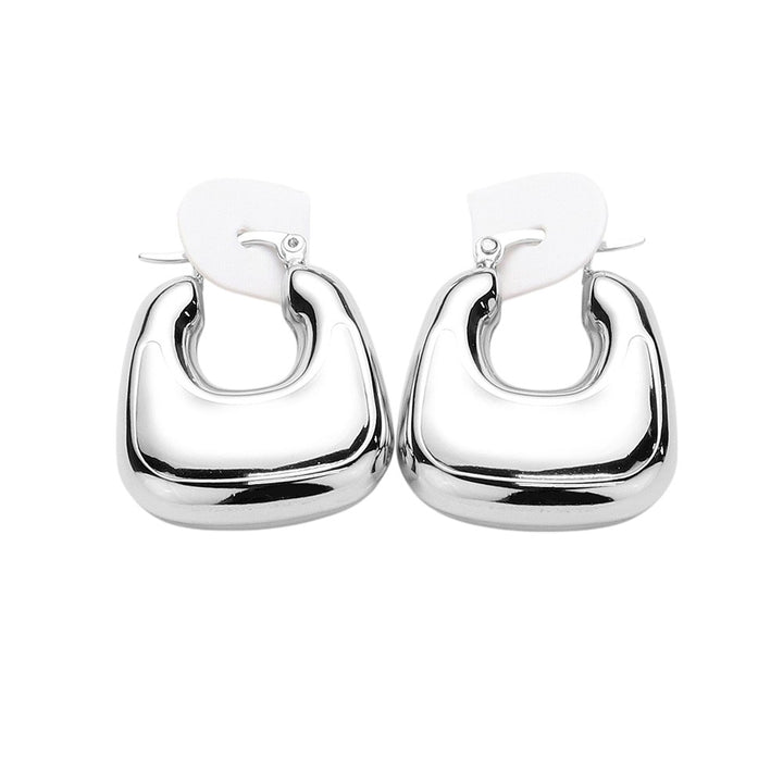 Rhodium Stainless Steel Chunky Hoop Pin Catch Earrings are made with high-quality stainless steel, ensuring durability and long-lasting shine. The secure pin catch design ensures they will stay in place while adding a statement to any outfit. The perfect mix of style and functionality.