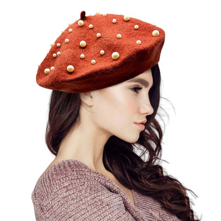 Rust-Pearl Embellished Tam Beret Hat, Featuring a classic beret design, this stylish hat is adorned with elegant pearls for a touch of sophistication.Adding a touch of glamour to any outfit, this hat is a must-have accessory for any fashion-forward individual.Upgrade your style today with our Pearl Embellished Tam Beret Hat