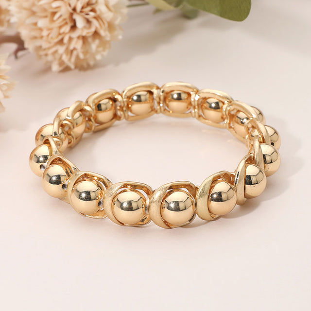 Madeline Love Gold, Worn Gold Sleek Metal Ball Beaded Stretch Bracelet