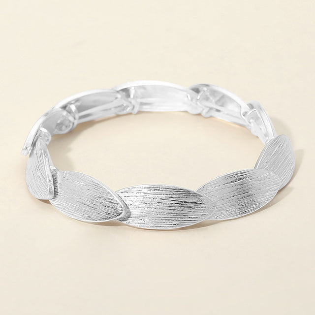 Madeline Love Worn Silver Textured Metal Oval Overlapped Beaded Stretch Bracelet - Bracelets