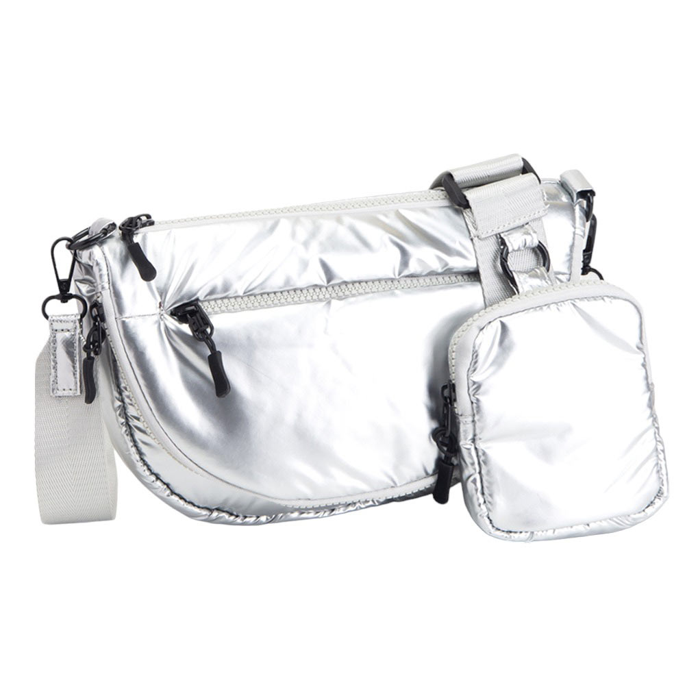 Silver Puffer Half Moon Crossbody Bag, the lightweight, stylish design features a durable water-resistant nylon that is perfect for outdoor activities. The adjustable shoulder strap makes it easy to sling across your body for hands-free convenience. Carry your essentials in style and comfort with this fashionable bag.
