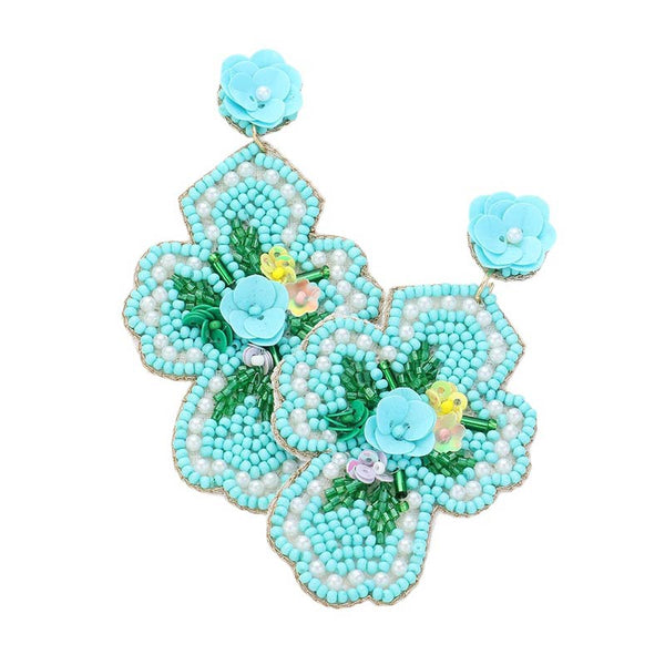 Mint Seed Beaded Flower Cross Dangle Earrings. Add a touch of elegance to your ensemble with our Seed Beaded Flower Cross. These handcrafted earrings feature a delicate flower design with a cross accent. Made with quality materials and intricate detailing, they are sure to elevate your style.