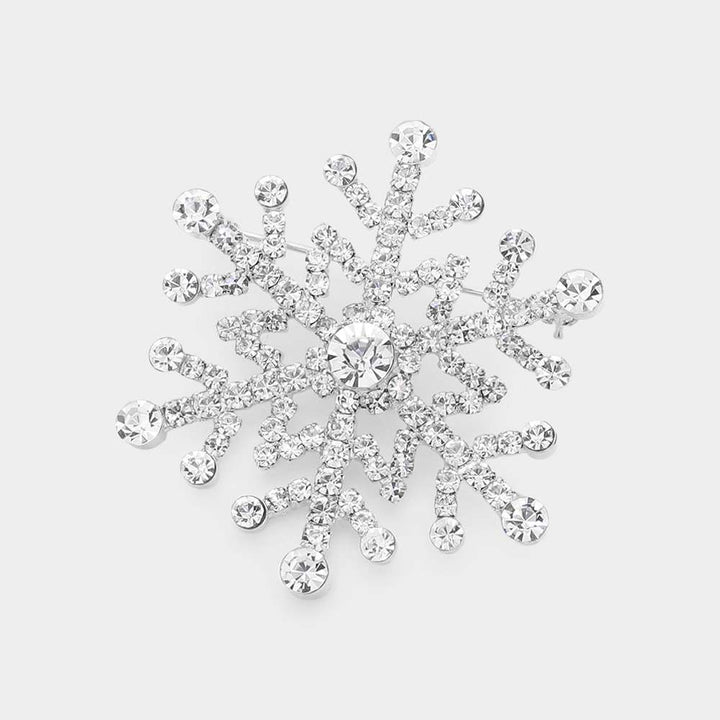 Elegant snowflake brooch pin adorned with sparkling rhinestones in a dazzling winter design. Perfect accessory for coats, scarves, and holiday outfits, adding festive sparkle and seasonal charm to any look. A perfect gift for Christmas.
