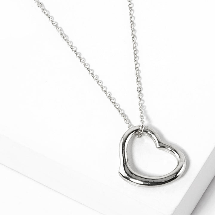 Metal Heart Cut-Out Pendant Necklace showcases a modern cut-out design, adding a touch of elegance to any outfit. Made with high-quality materials, this necklace is both durable and stylish. Elevate your look with this versatile accessory that perfectly blends beauty and functionality. 