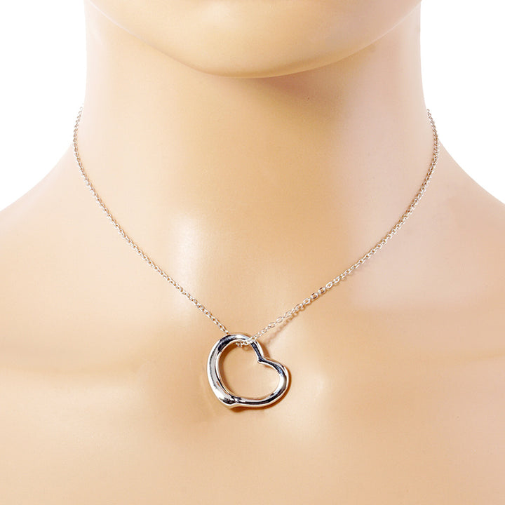 Silver Metal Heart Cut-Out Pendant Necklace showcases a modern cut-out design, adding a touch of elegance to any outfit. Made with high-quality materials, this necklace is both durable and stylish. Elevate your look with this versatile accessory that perfectly blends beauty and functionality. 