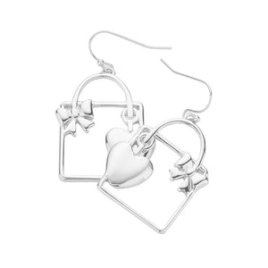 Unlock your heart (and style) with these quirky Silver Metal Heart Ribbon Lock Gift Box Dangle Earrings. Perfect for Valentine's Day, Dia del Amor (or any day!), these playful earrings will add a touch of fun to any outfit. Plus, the unique lock and key design is an ode to the power of love. Birthday Gift, Regalo Cumpleanos.