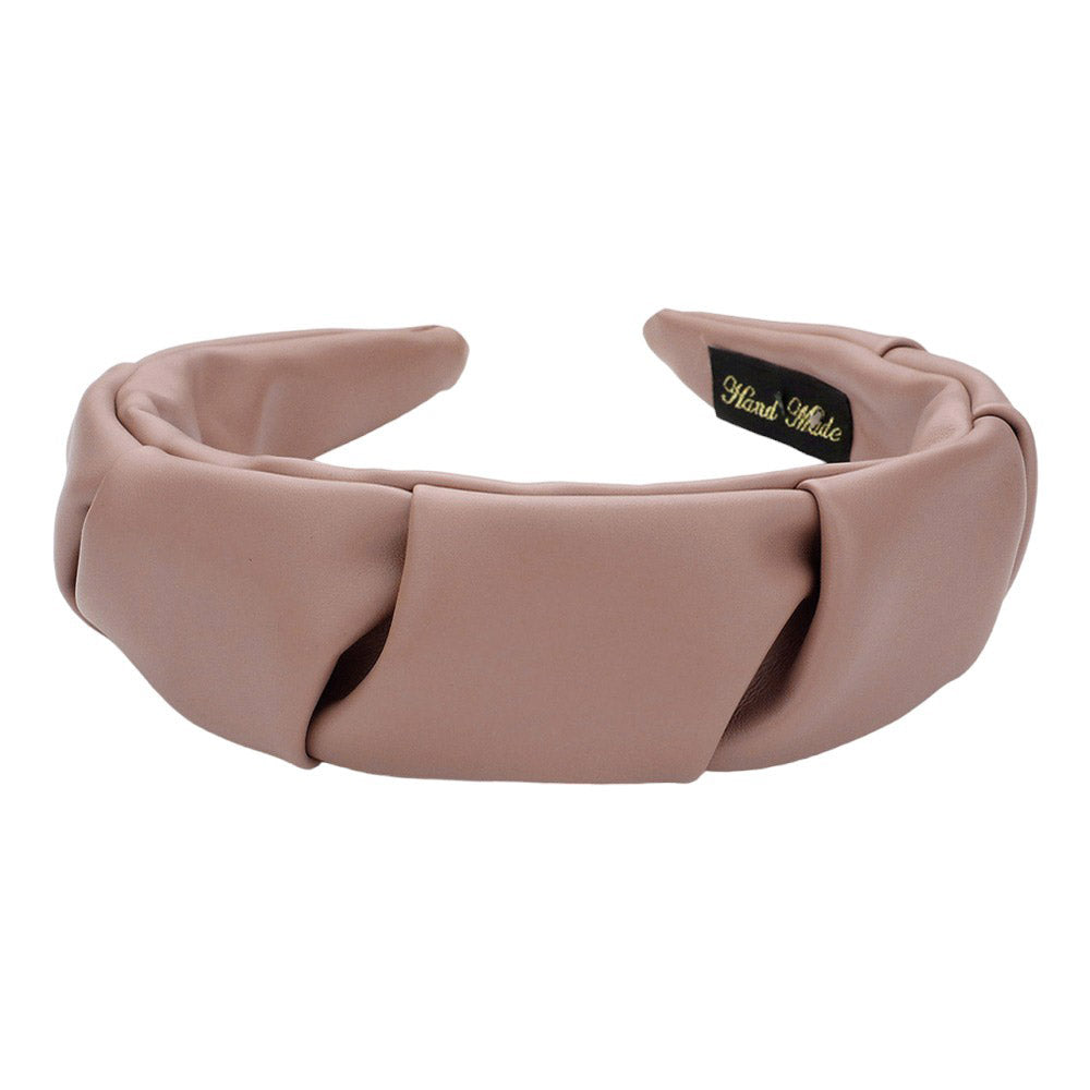 Tan Pleated Solid Faux Leather Headband, This stylish accessory adds an elegant touch to any outfit. Made with high-quality materials, it is both comfortable and durable. The pleated design offers a unique, sophisticated look, while the faux leather adds a touch of luxury. Perfect for any formal or casual occasion wear.