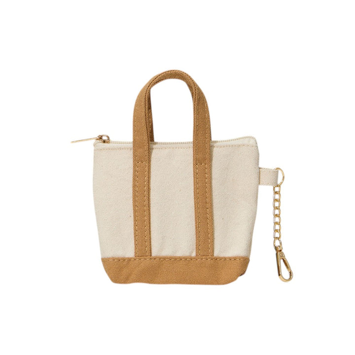 Taupe Mini Canvas Pouch Bag doubles as a chic bag charm, combining style with practicality. Crafted from durable canvas, it offers a compact space perfect for carrying essentials like keys, cards, or small cosmetics. Its lightweight design attaches easily to your handbag, adding a trendy accent while keeping your valuables within reach. Ideal for those who value convenience and a polished look in everyday accessories.