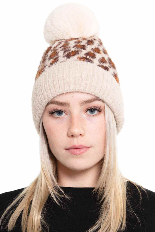Taupe Cozy up in this Leopard Pom Fleece Beanie, featuring a playful leopard print design with a fuzzy pom-pom on top. Made from a soft blend of 50% acrylic and 50% nylon, this beanie delivers warmth and comfort for chilly days.