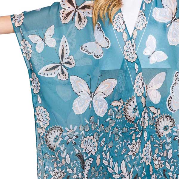 Teal Butterfly and Flower Print Kimono Poncho, is a stylish addition to any wardrobe or a perfect gift. Made from high-quality materials, it features a beautiful butterfly and flower print that adds a touch of elegance to any outfit. Its versatile design allows for effortless layering, making it perfect for any occasion.