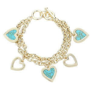 Turquoise Mother Of Pearl Heart Charm Layered Toggle Bracelet, Discover the elegance. This bracelet features stunningly intricate mother of pearl heart charms that exude sophistication and timeless beauty. The layered design adds a unique touch to this classic piece, making it the perfect accessory for any occasion.