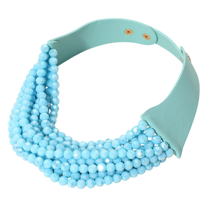 Turquoise  Chunky Acrylic Beaded Multi Layered Faux Leather Necklace is a stylish accessory that adds a touch of elegance to any outfit. The chunky acrylic beads and multi-layered design make it a bold statement piece. Made with faux leather, it is also durable and long-lasting. Perfect for any occasion, this necklace is a must-have for any fashion-forward individual. 