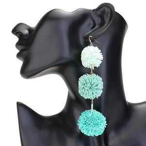 Turquoise Raffia Pom Pom Link Dropdown Earrings, These unique earrings combine the natural texture of raffia with playful pom poms to add a touch of whimsy to any outfit. The link design gives them a modern, chic feel while the dropdown style elongates the neck. Elevate your style with these statement earrings.