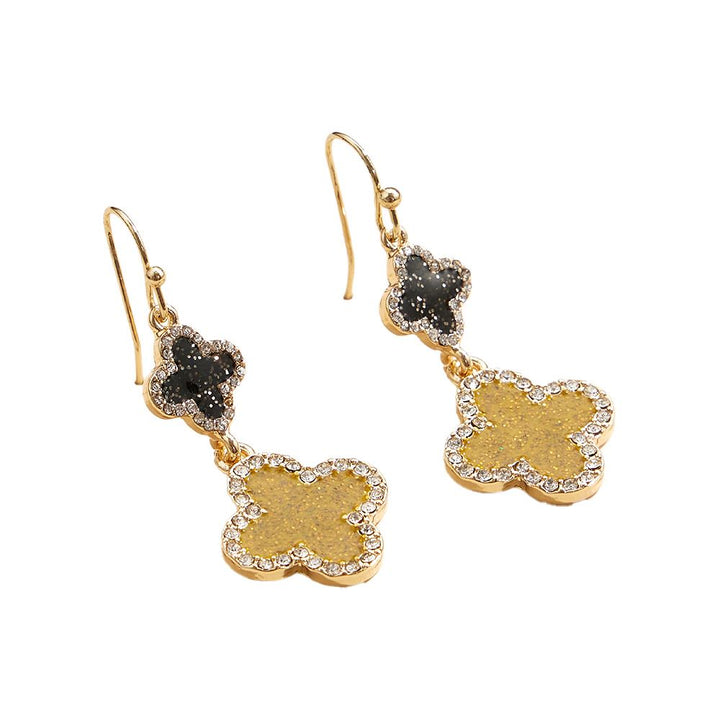 Two-Tone-Stone Rim Glittered Quatrefoil Link Dangle Earrings feature a unique design with sparkling accents. The quatrefoil links and glittered rim add a touch of elegance to any outfit. The dangle style allows for movement and catches the light beautifully. Perfect for adding a touch of sophistication to your look. 