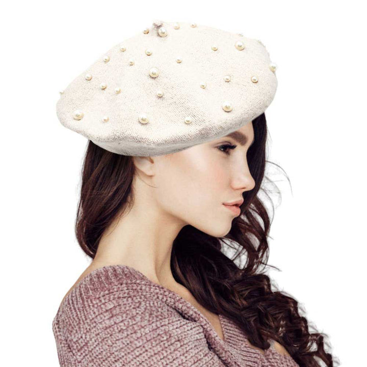 White-Pearl Embellished Tam Beret Hat, Featuring a classic beret design, this stylish hat is adorned with elegant pearls for a touch of sophistication.Adding a touch of glamour to any outfit, this hat is a must-have accessory for any fashion-forward individual.Upgrade your style today with our Pearl Embellished Tam Beret Hat