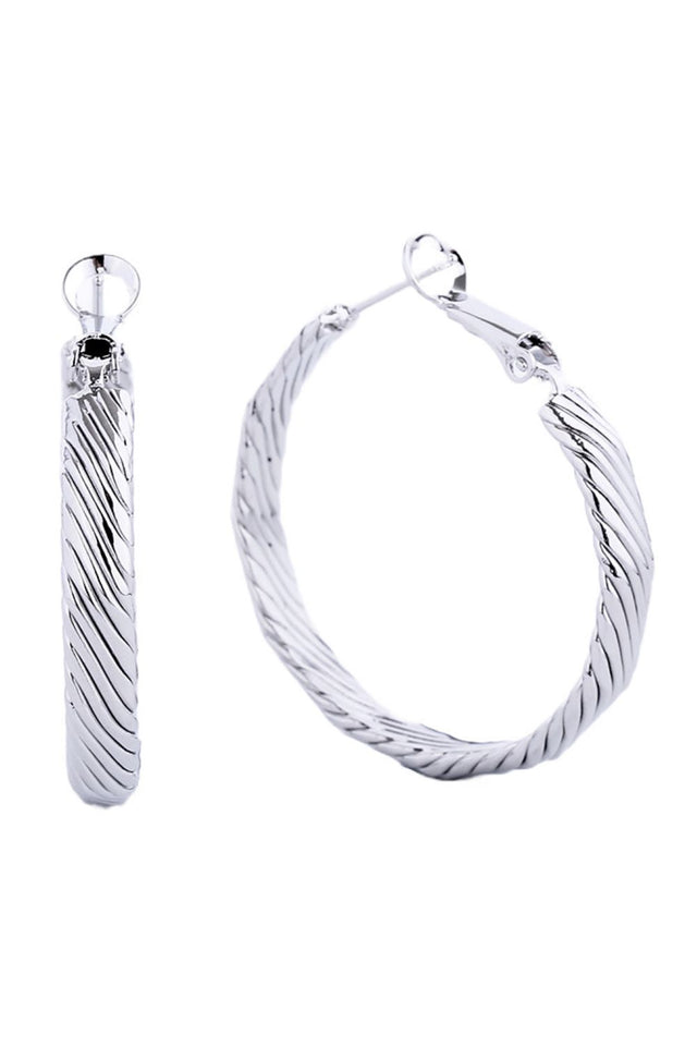 White Gold Elegant hoop earrings crafted from hypoallergenic brass with a luxurious 14K gold and white dip finish. Featuring a secure omega closure for all-day wear, these 3.5cm diameter hoops offer timeless style with modern comfort. Lead and nickel compliant, making them perfect for sensitive skin. A versatile essential that transitions effortlessly from casual to formal occasions.