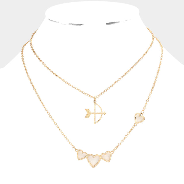 Worn Gold 2-piece set of Cupid's Arrow Heart Pendant Necklaces is the perfect romantic gift. Crafted with delicate detail, the pendants feature intertwined arrows and hearts, symbolising a deep and everlasting love. Made from high-quality materials, these necklaces are both stylish and durable. Give the gift of love with this jewelry set.