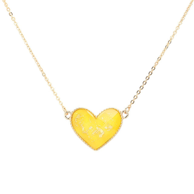 Yellow Gold Foil Detailed Heart Pendant Necklace adds a touch of elegance to any outfit. The intricate gold foil detailing highlights the delicate heart pendant, creating a timeless and sophisticated piece. Crafted with high-quality materials, this necklace is sure to make a statement and elevate your style.